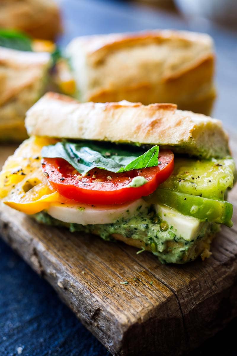 These Caprese Sandwiches are the perfect summer lunch- made with juicy ripe tomatoes, fresh mozzarella cheese, fresh basil, and pest0-mayo on a baguette, they are great made ahead or packed for picnic lunches on the go.