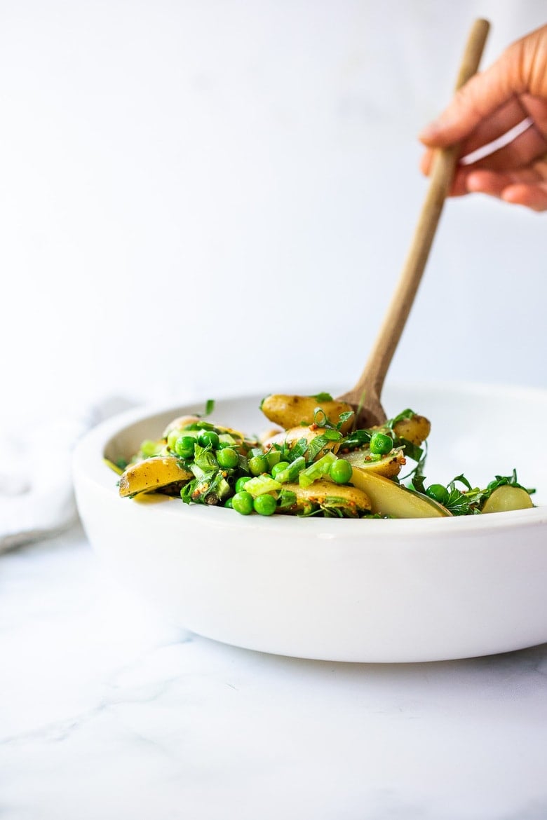 Potato Pea Salad with an herby Tarragon dressing. This zesty, vegan potato salad is loaded with fresh herbs and flavor! A delicious, healthy salad that can be made ahead. #potatosalad