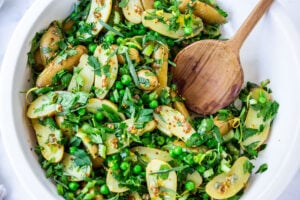 Potato Pea Salad with an herby Tarragon dressing. This zesty, vegan potato salad is loaded with fresh herbs and flavor! A delicious, healthy salad that can be made ahead. #potatosalad