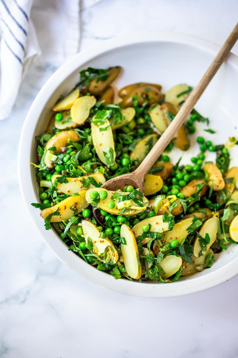 Potato Pea Salad with an herby Tarragon dressing. This zesty, vegan potato salad is loaded with fresh herbs and flavor! A delicious, healthy salad that can be made ahead. #potatosalad