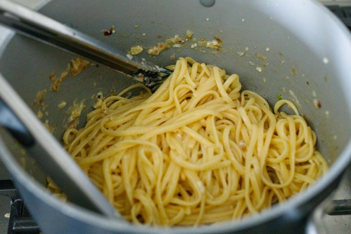 tossing the pasta with the creamy miso sauce.