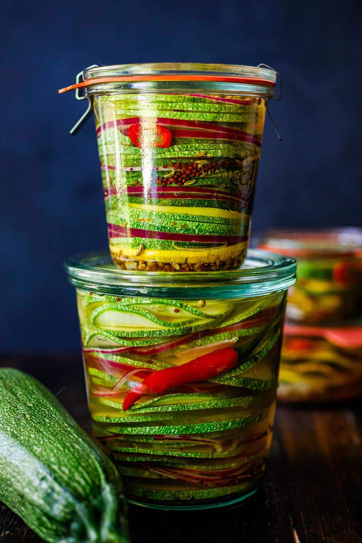 pickled zucchini in two jars, stacked.  