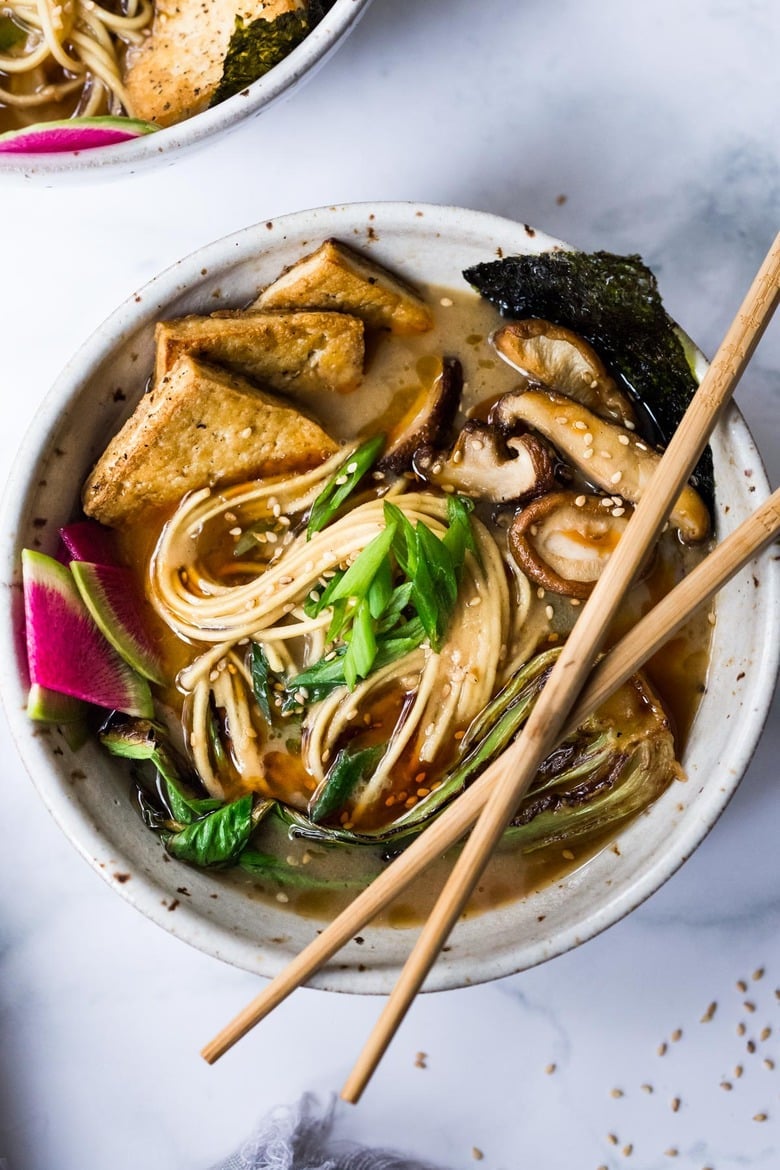Vegan Ramen with Miso Shiitake Broth with tofu and veggies in a bowl and chopsticks on top.