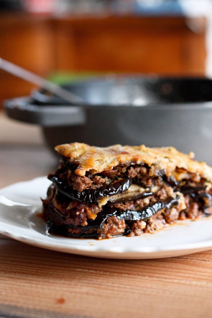 An authentic, delicious recipe for Eggplant Moussaka- with a Tomato lamb sauce, and creamy béchamel sauce. Vegetarian Adaptable! Can be made ahead and baked prior to serving.