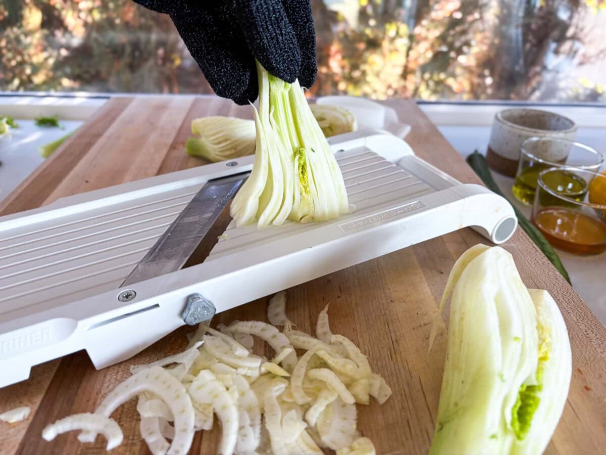 shaving fennel bubls on a mandolin. 