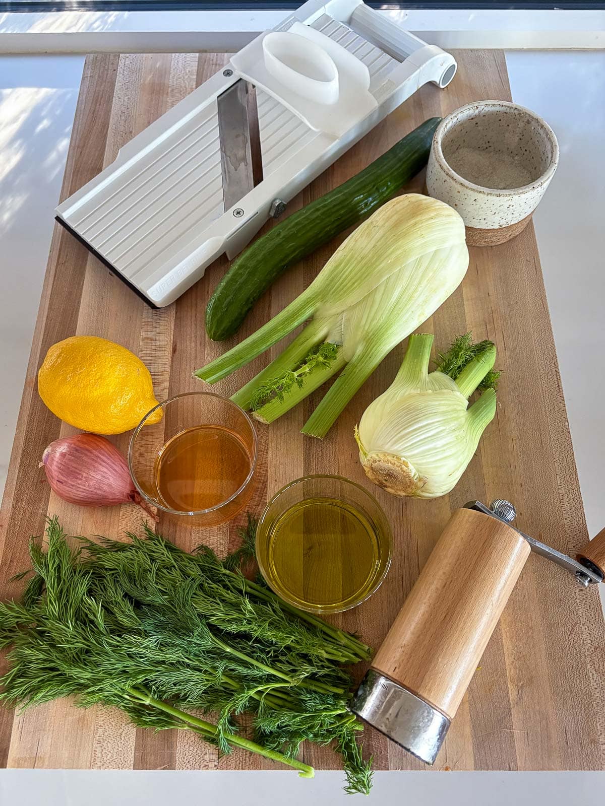 ingredients in fennel salad- fennel bulbs, cucumber, onion, salt, pepper, meyer lemon and olive oil. 