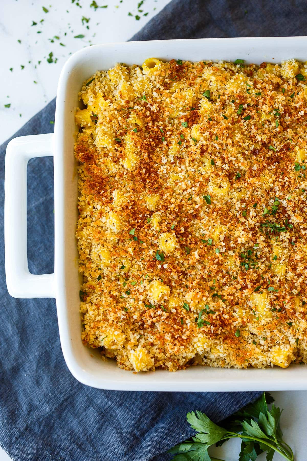 vegan mac and cheese in a baking pan with crispy breadcrumb topping.