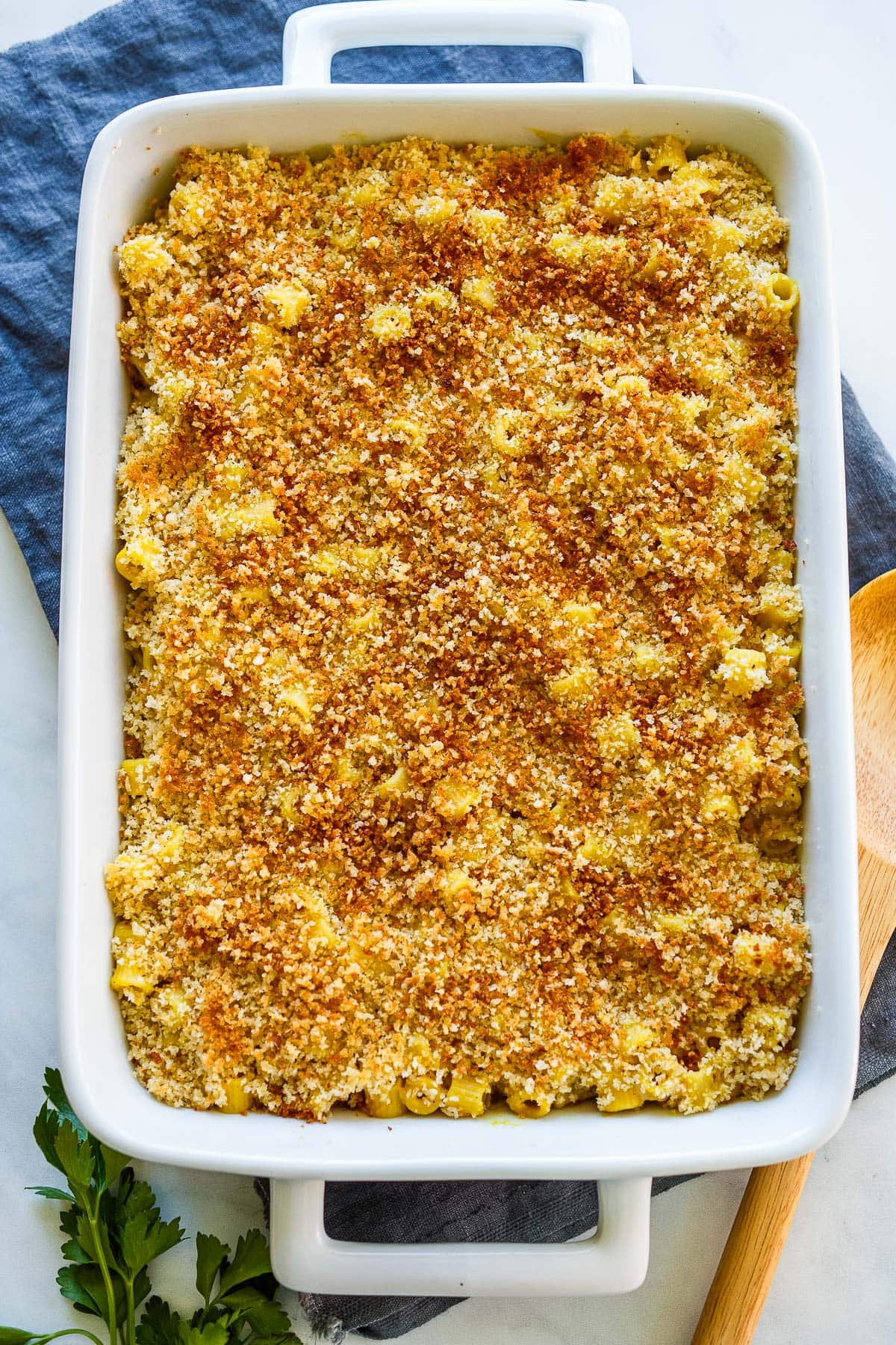 baked vegan mac and cheese in casserole dish with breadcrumb topping.