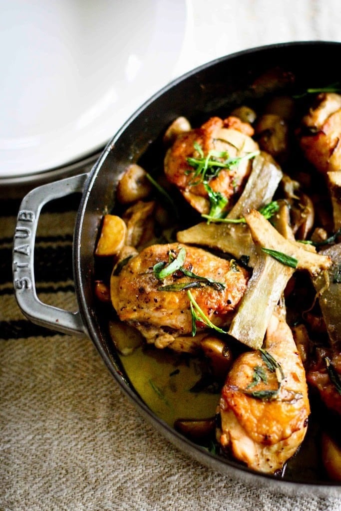 Crispy Braised Chicken Thighs with Artichoke hearts, leeks, potatoes and tarragon- a delicious, French-inspired one-pan recipe perfect for spring!