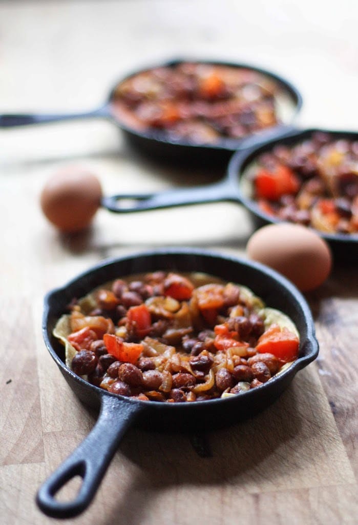 Huevos Rancheros Skillet Eggs- with hearty beans, crispy tortilla, avocado and fresh tomato and cilantro...so simple and tasty! | www.feastingathome.com