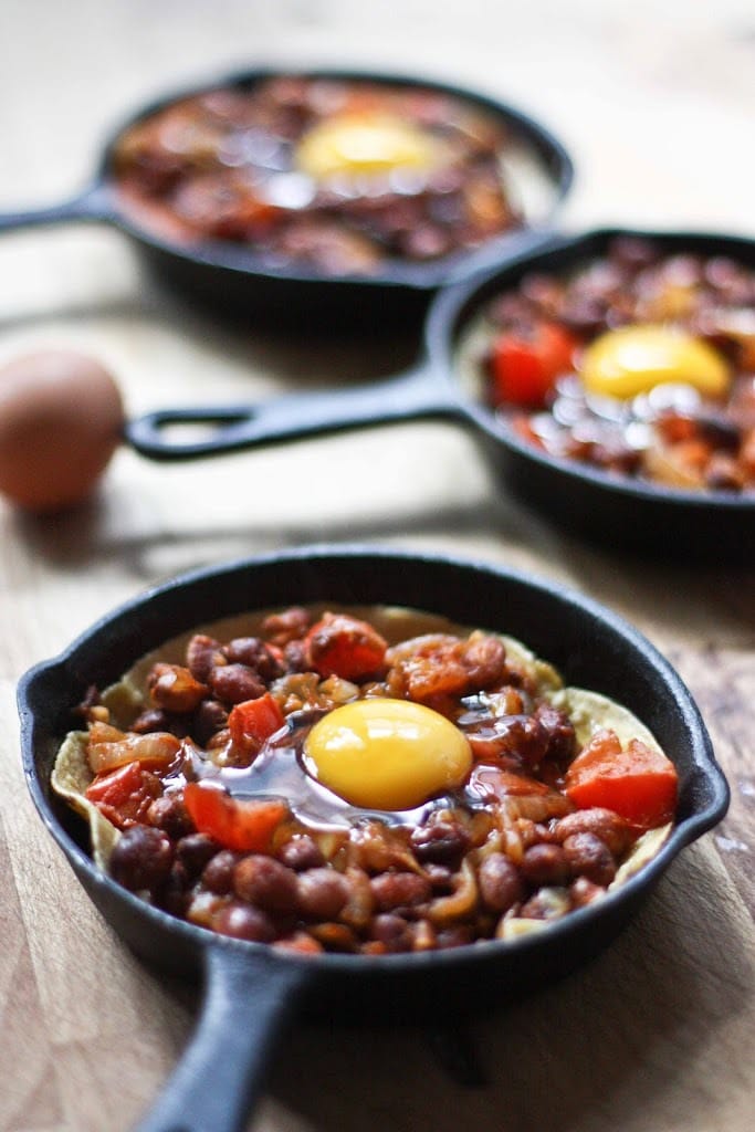 Huevos Rancheros Skillet Eggs- with hearty beans, crispy tortilla, avocado and fresh tomato and cilantro...so simple and tasty! | www.feastingathome.com