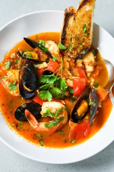 This summery Seafood Stew recipe highlights a light, flavorful tomato-fennel broth with fresh fish and seafood and optional chorizo.