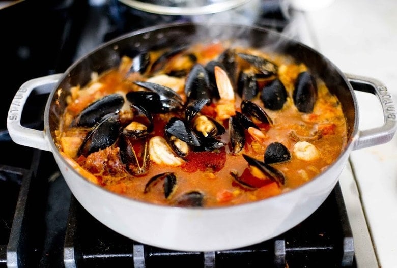 Seafood stew simmering on the stove.