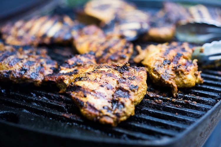 Grilled Tandoori Chicken- an easy authentic Indian recipe with a simple yogurt marinade using chicken thighs. Served with naan and Raita Sauce. #tandoorichicken #grilled #grilledchicken #indianrecipe