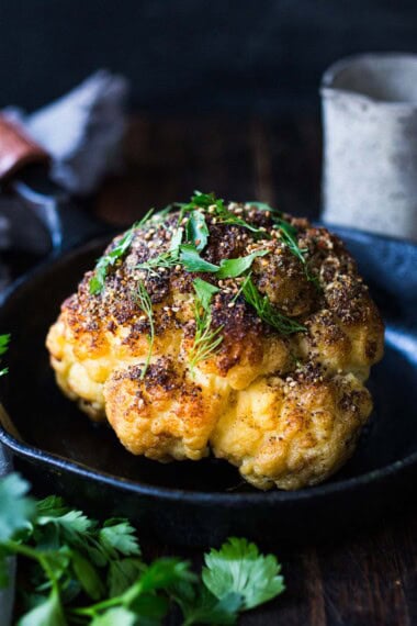 Za'atar spiced, whole roasted cauliflower recipe with tahini sauce.