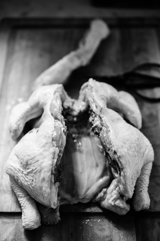 Removing the backbone from the chicken.