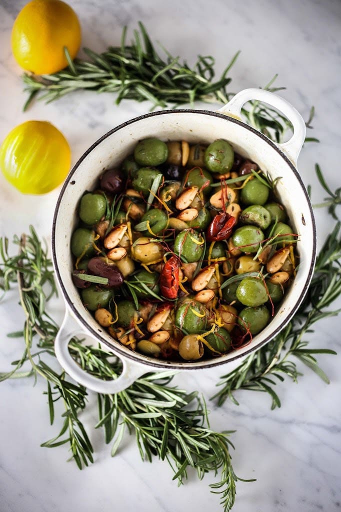 These warm olives are such an easy, delicious appetizer! Made with Castelvetrano olives, lemon zest, rosemary, garlic, and Marcona almonds, they are perfect for your next gathering. 