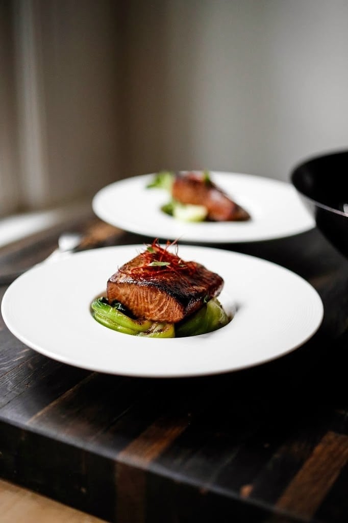 Finished dish: tea-smoked, five-spice salmon, plated and garnished.