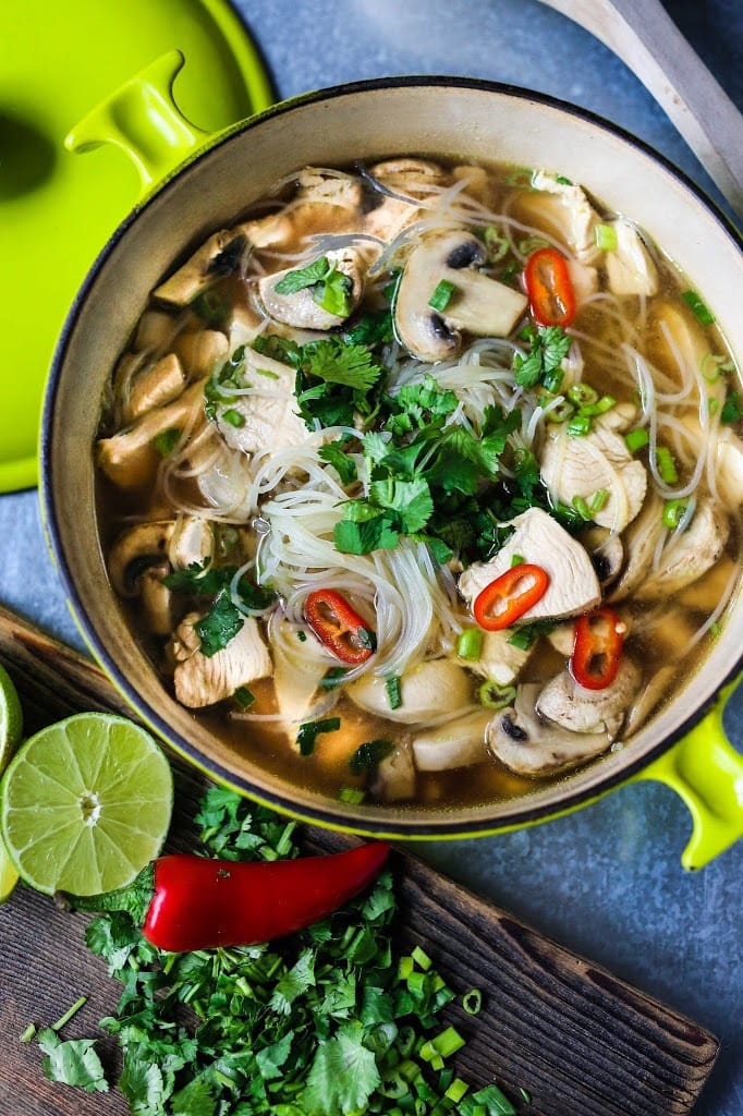 A steaming bowl of Thai Chicken Noodle Soup infused with lemongrass and ginger. A healthy, low fat, gluten-free meal, full of amazing Thai flavors! #thaisoup #chickensoup #thainoodlesoup #lemongrass #broth #brothysoup