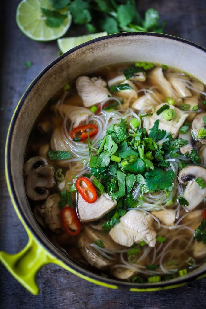 A steaming bowl of Thai Chicken Noodle Soup infused with lemongrass and ginger. A healthy, low fat, gluten-free meal, full of amazing Thai flavors!