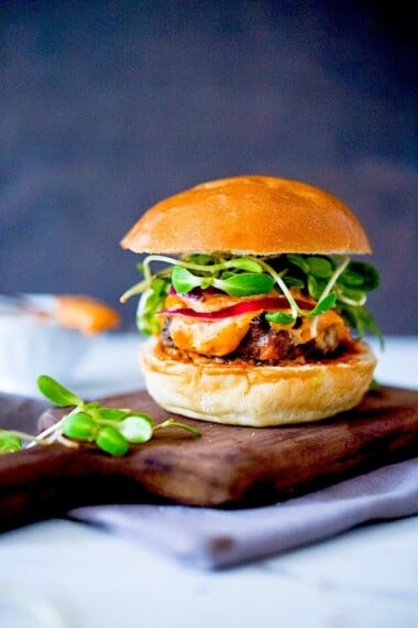 Grilled Lamb Burgers with Harissa Aioli, melty cheese, arugula and pickled onions served on a toasted Brioche Bun. Bacon optional.;) #lambburger #grilledlamb #harissa #harissaburger #bestburger