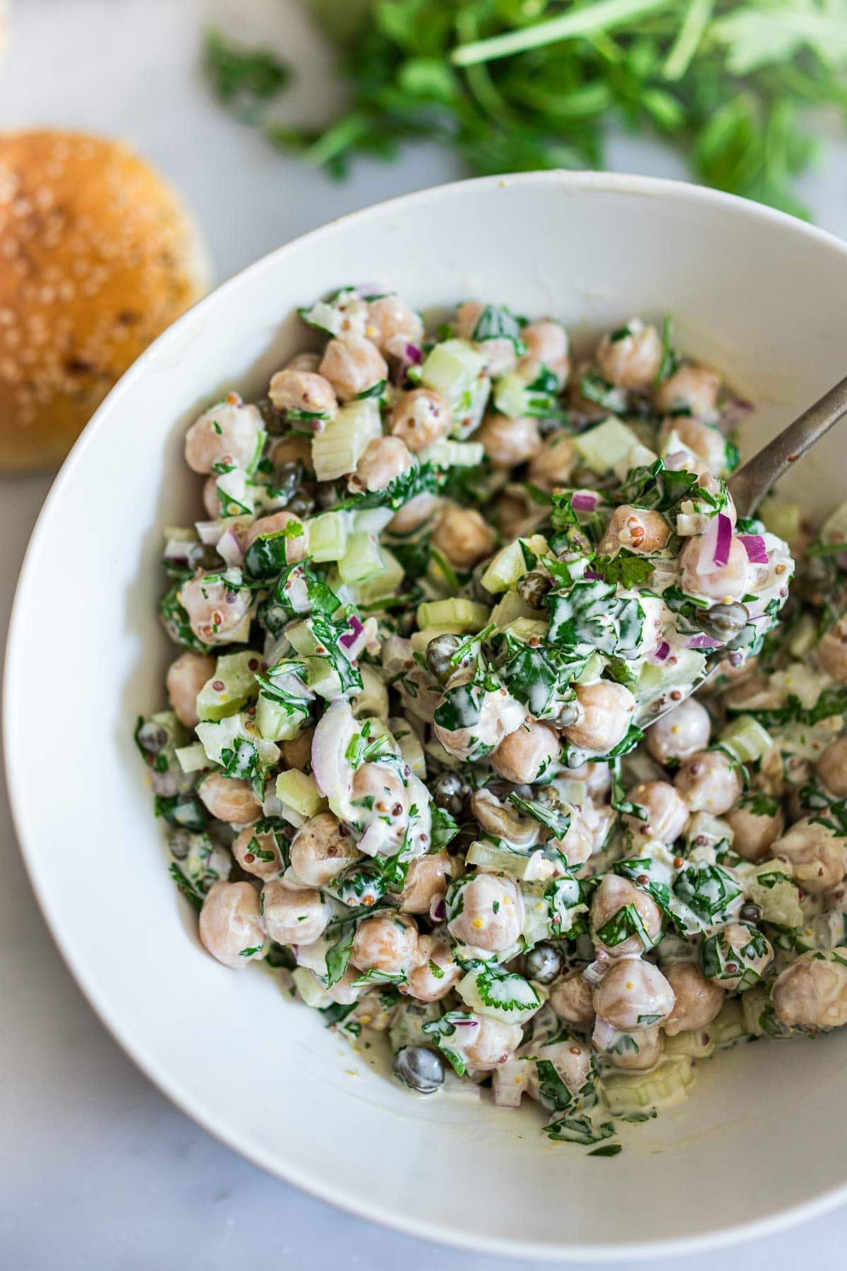 mixing bowl and spoon with chickpea salad. 