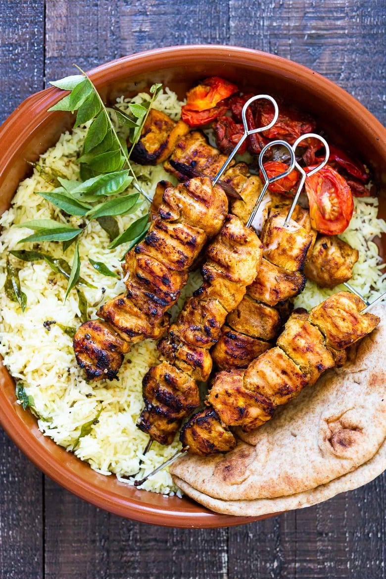 Grilled Tandoori Chicken- an easy authentic Indian recipe with a simple yogurt marinade using chicken thighs. Served with naan and Raita Sauce. #tandoorichicken #grilled #grilledchicken #indianrecipe