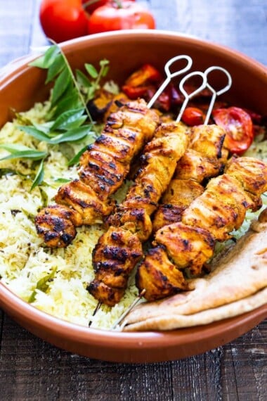 Grilled Tandoori Chicken- an easy authentic Indian recipe with a simple yogurt marinade using chicken thighs. Served with naan and Raita Sauce. #tandoorichicken #grilled #grilledchicken #indianrecipe