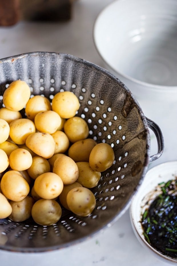 Grilled potato salad with a black garlic vinaigrette...a flavorful, lightened-up potato salad to serve alongside grilled meat or fish! Serve this warm or chilled. #grilled #potatosalad #blackgarlic #healthypotatosalad #vegan