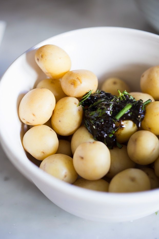 Grilled potato salad with a black garlic vinaigrette...a flavorful, lightened-up potato salad to serve alongside grilled meat or fish! Serve this warm or chilled. #grilled #potatosalad #blackgarlic #healthypotatosalad #vegan