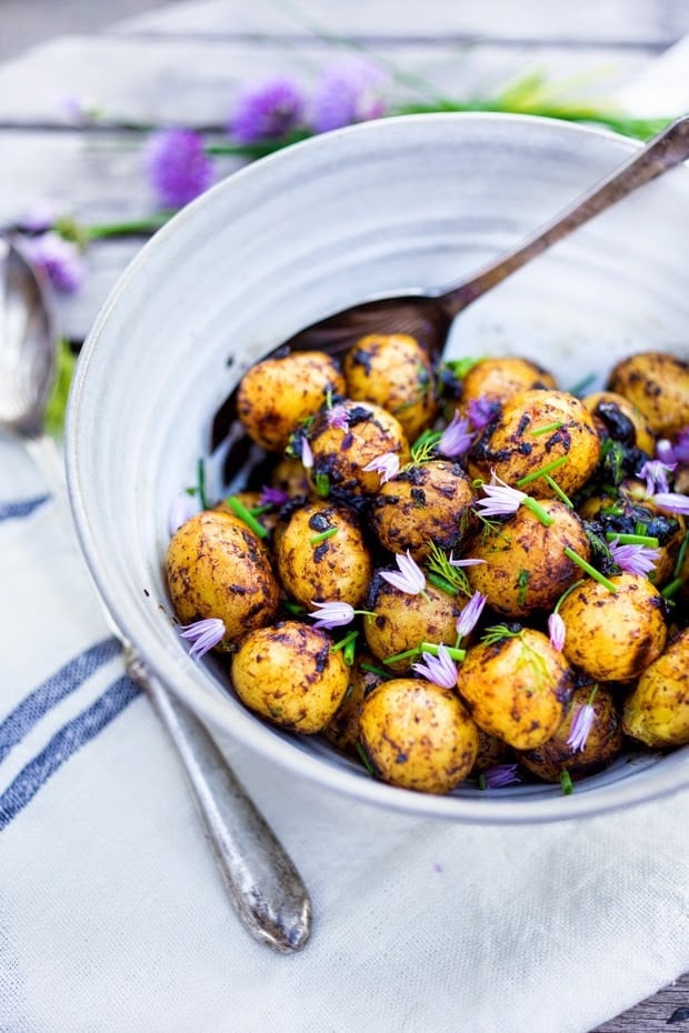 Grilled potato salad with a black garlic vinaigrette...a flavorful, lightened-up potato salad to serve alongside grilled meat or fish! Serve this warm or chilled. #grilled #potatosalad #blackgarlic #healthypotatosalad #vegan