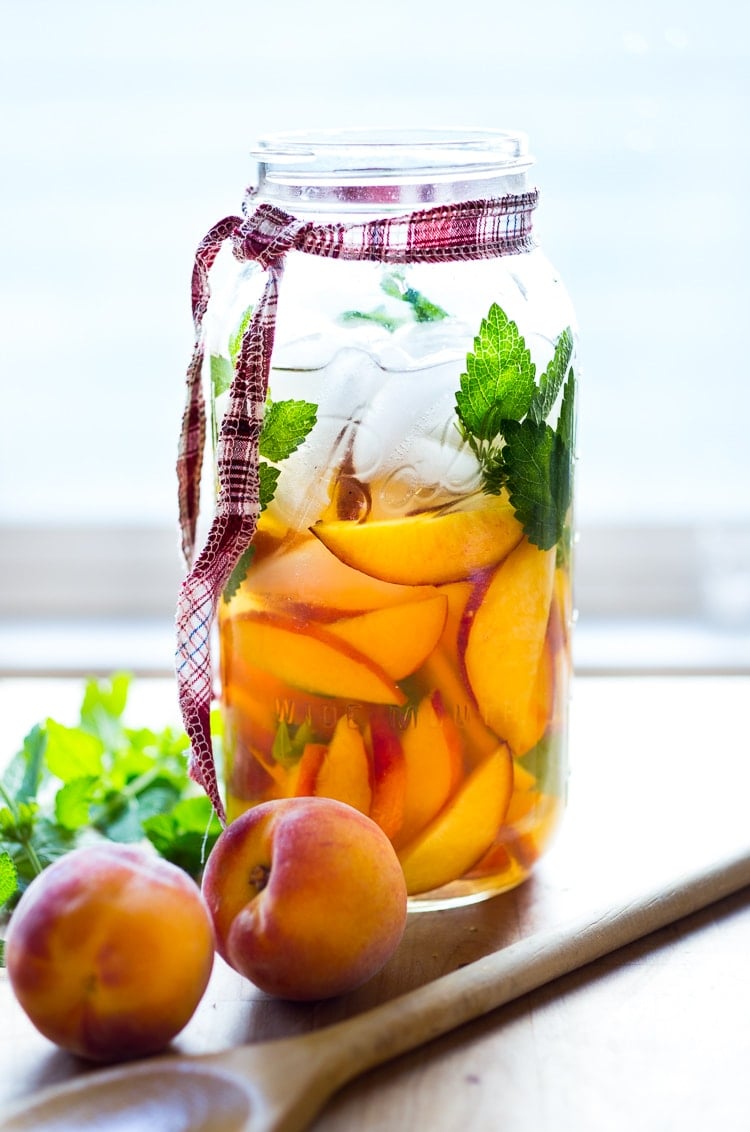 peach sangria Simple Refreshing Peach Sangria ...a delicious summer cocktail made with white wine and Elder flower liquor (or syrup) that can be made ahead. Perfect for a crowd! #peachsangria #peach #sangria | www.feastingathome.com