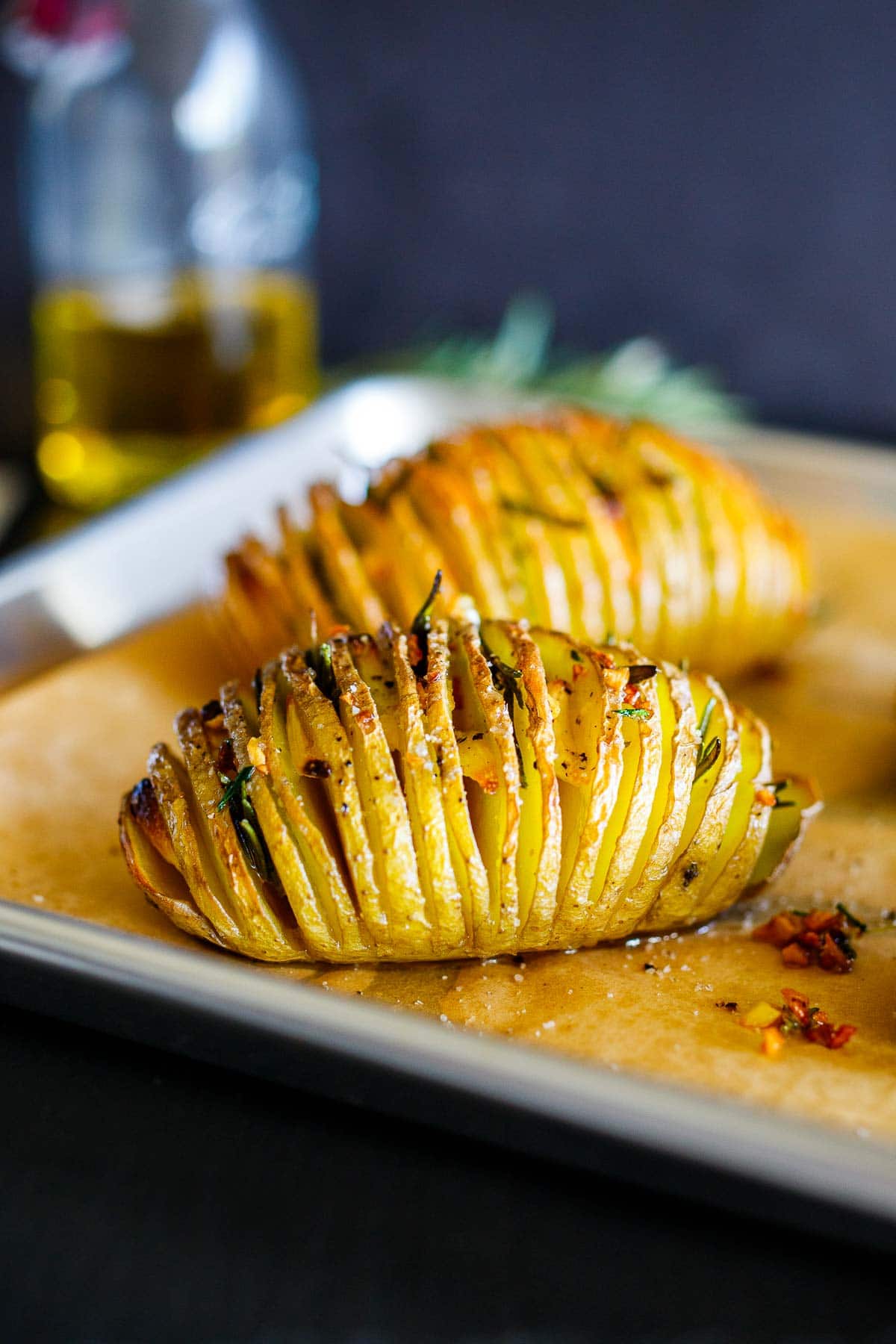 Golden brown Hasselback Potatoes on a sheet pan, coming out of the oven.