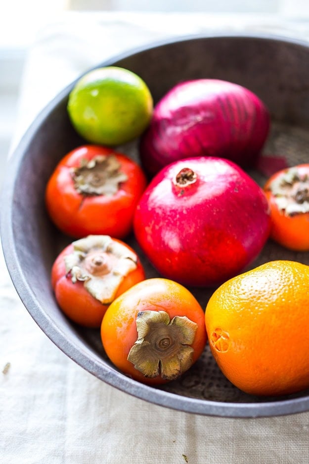 Persimmon, pomegranate and shaved fennel salad with honey citrus dressing. vegan, gf | www.feastingathome.com large bowl of persimmon, orange, pomegranate, and lime.
