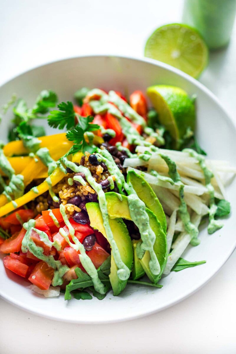 This Burrito bowl recipe is way better than Chipotle takeout! Made with rice and beans and fresh, healthy veggies, it's easy, adaptable and full of flavor! Perfect for meal prepping, vegan, vegetarian, gluten-free.