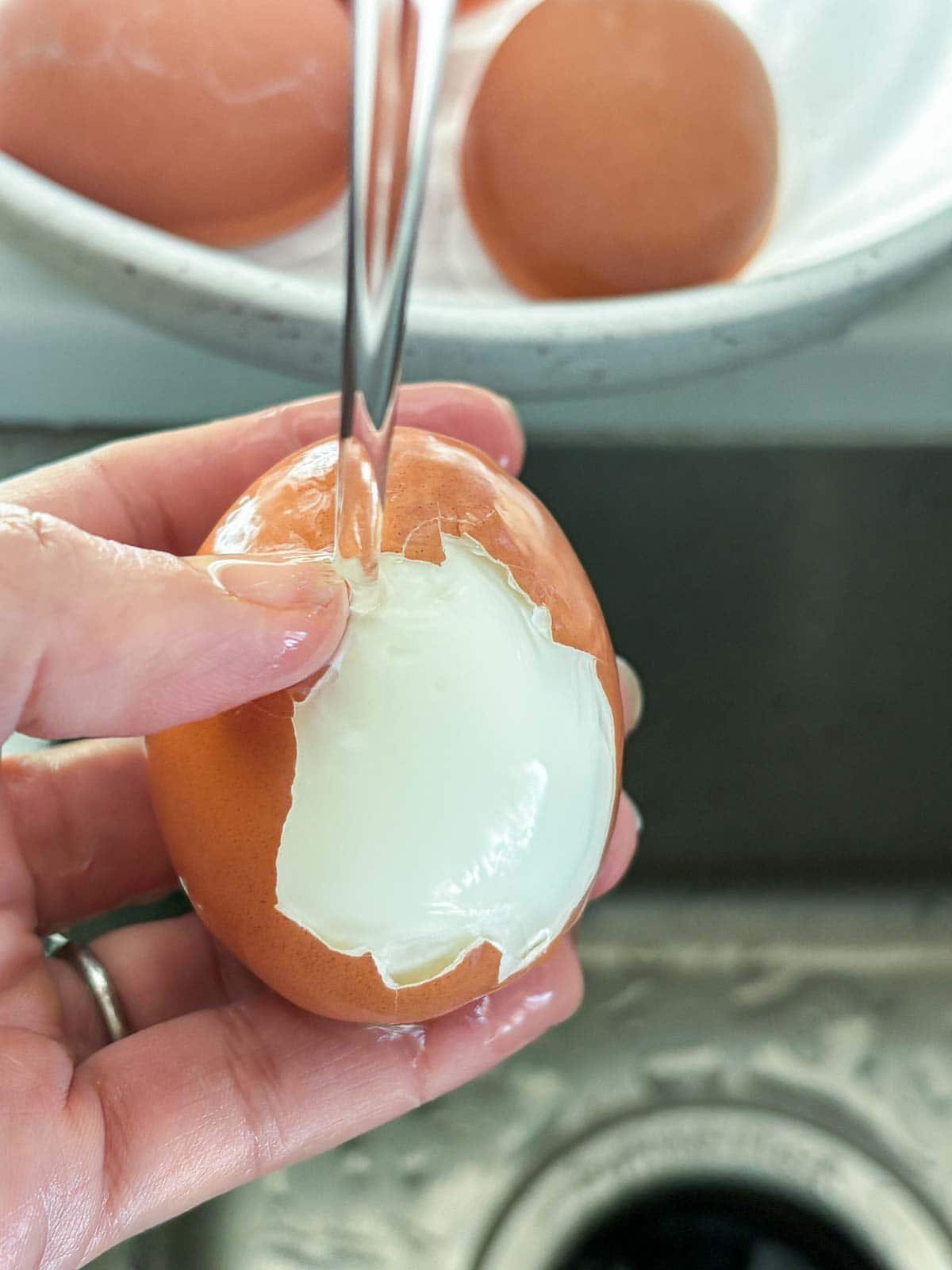 peeling the eggs under running cold water. 
