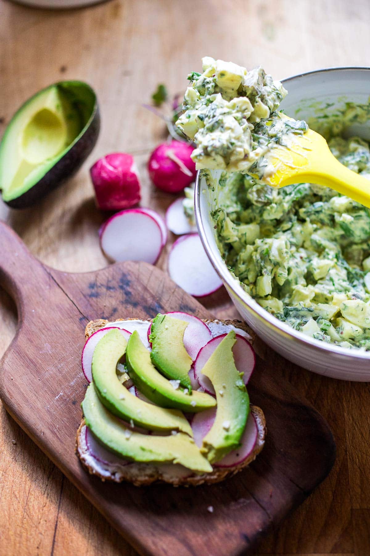 making an egg salad sandwich. 