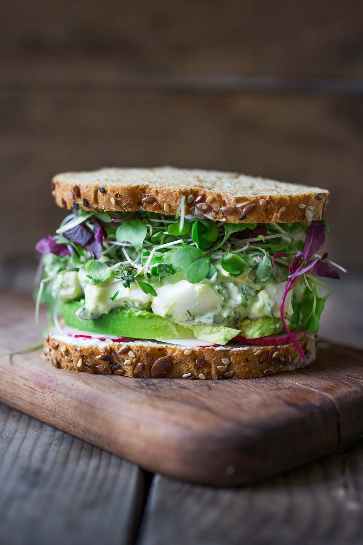 Dilly Egg Salad served in a sandwich with microgreens.