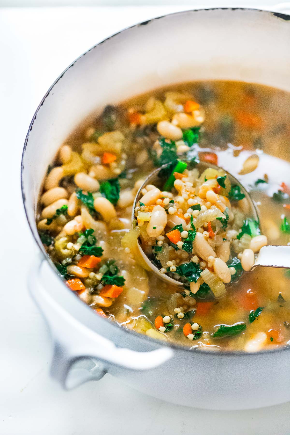 A pot full of sorghum and cannellini bean soup. 