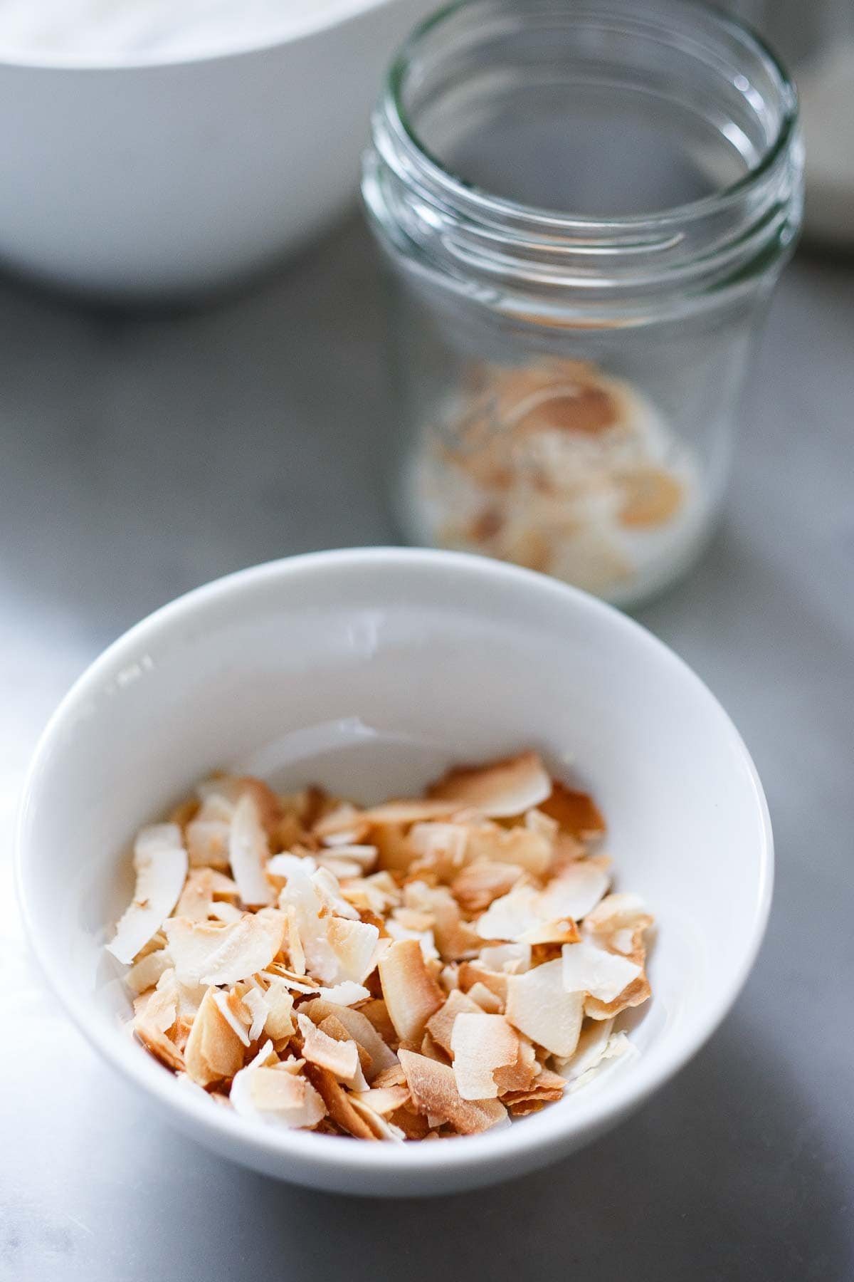 toastes coconut flakes in a bowl.