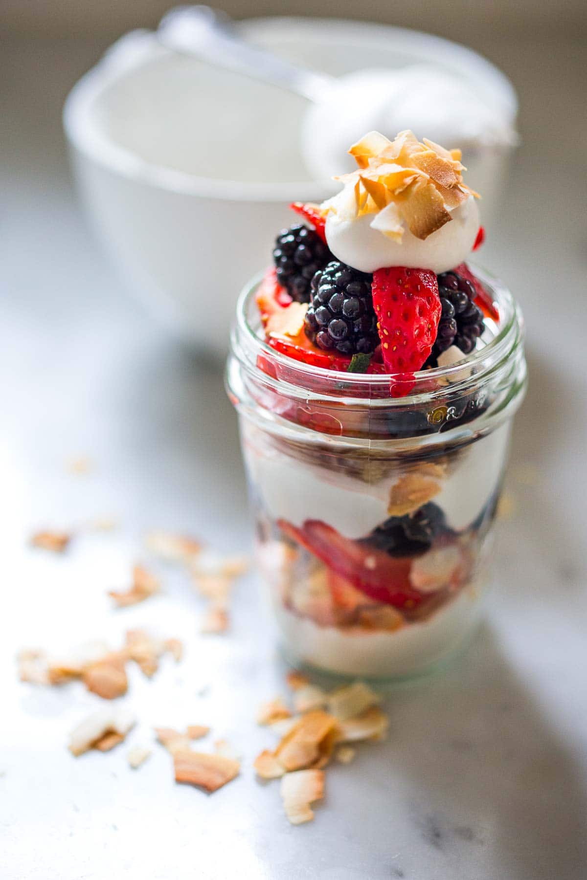 This fresh berry trifle recipe is refreshing, light, and delicious!  It's made with vegan lemon cake and coconut whipped cream and fresh berries- a simple make-ahead dessert, perfect for spring and summer gatherings. Vegan. 