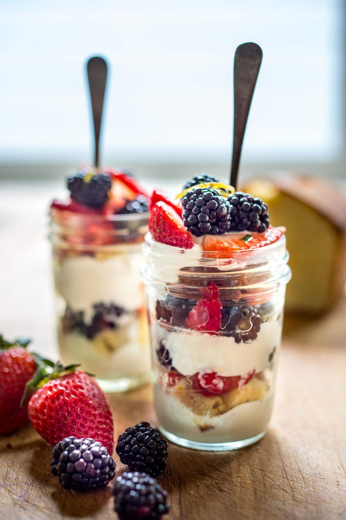 This fresh berry trifle recipe is refreshing, light, and delicious!  It's made with vegan lemon cake and coconut whipped cream and fresh berries- a simple make-ahead dessert, perfect for spring and summer gatherings. Vegan. 