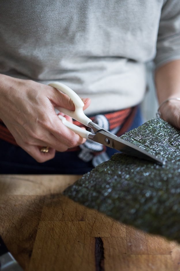 cutting nori in half. 