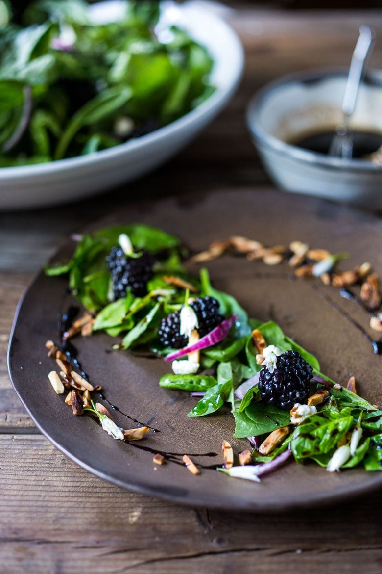 a photo of a plated blackberry salad with balsamic glaze on the plate.