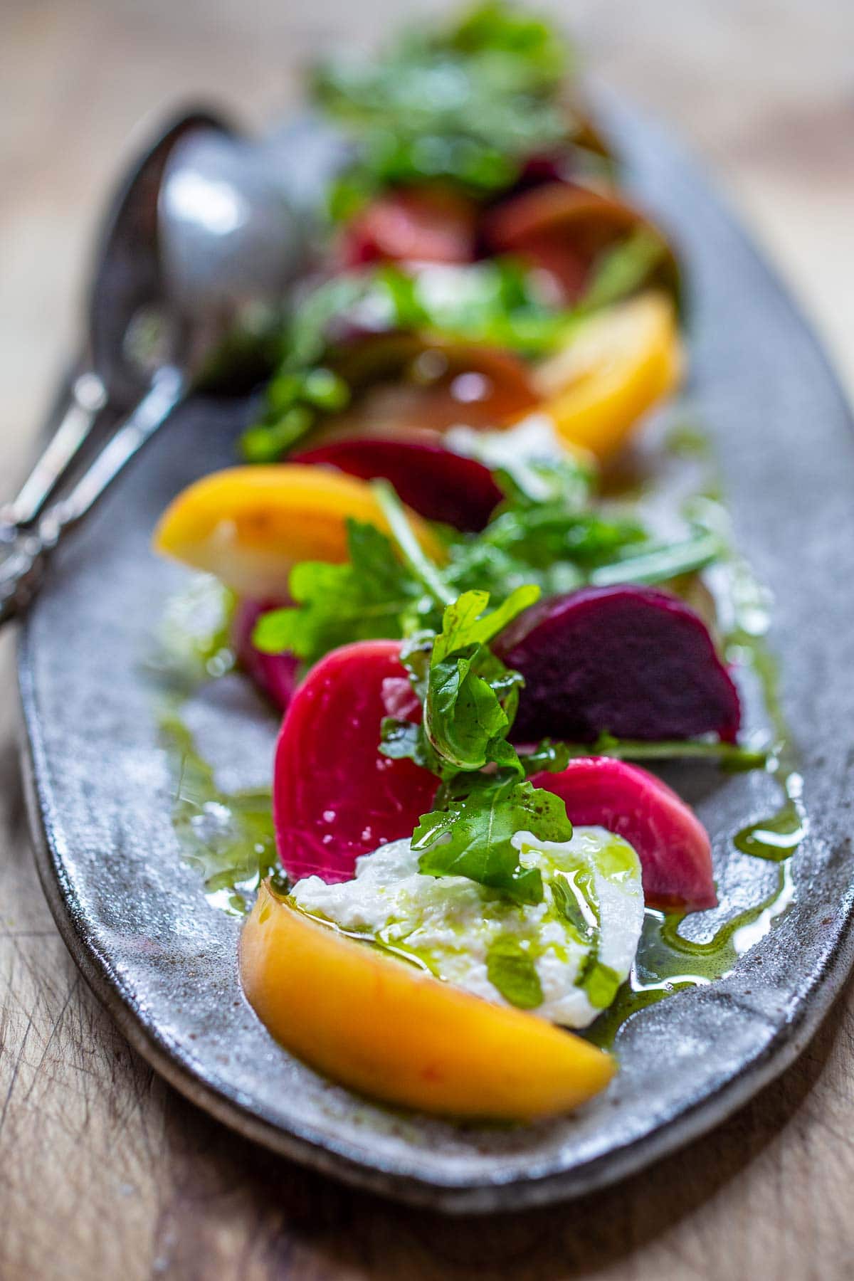 beet and tomato salad A beautiful Burrata Salad with tomatoes, beets, basil and flavorful basil oil, drizzled with balsamic glaze - perfect for summer dinners and gatherings. Elegant and flavorful.