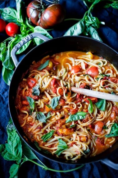 Spaghetti and fresh pasta sauce in a pan.