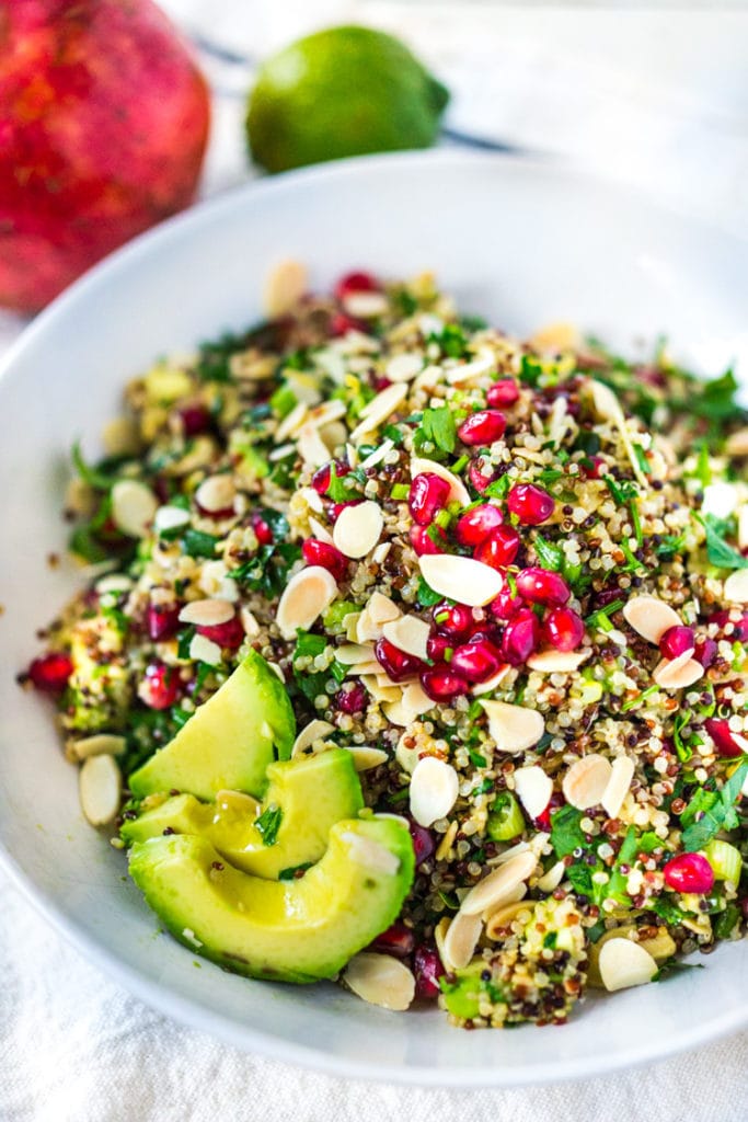 This Holiday Crunch Salad is bursting with flavor! Made with quinoa, pomegranate seeds, avocado, toasted almonds, and fresh parsley, it's a festive, healthy, vegan, gluten-free salad, perfect for the holiday table!