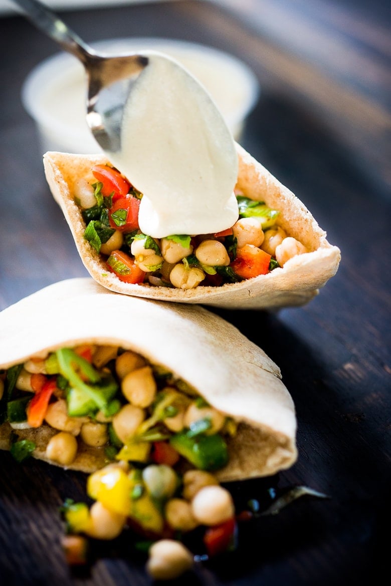 A simple & delicious recipe for Balela Salad, made w/ finely chopped vegetables, chickpeas, fresh herbs, lemon & olive oil. Serve in a pita with tahini sauce or over greens. | www.feastingathome.com