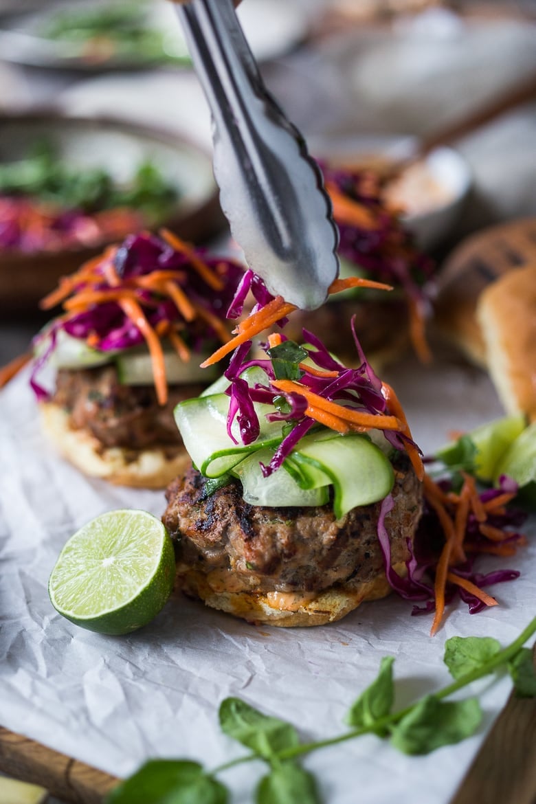 Assembling the Thai Turkey Burgers with slaw and cucumber.