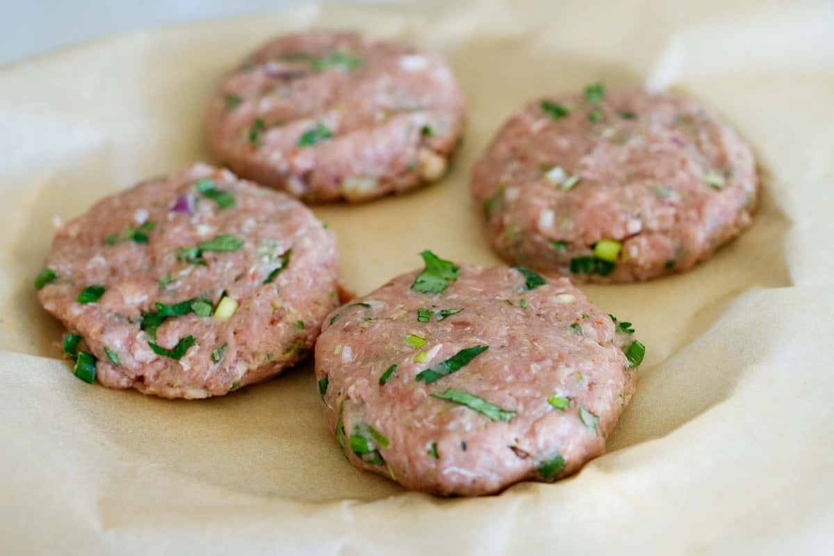 shaping the turkey burgers in to 4 patties, on a plate with parchement. 